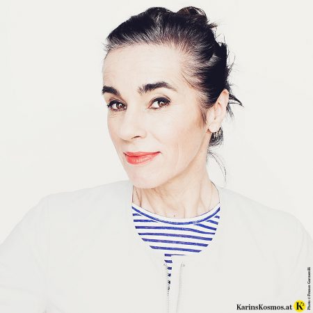 Ist graues Haar schön? Hier eine Frau mit einem Ansatz von vier Zentimeter langem grauem Haar.